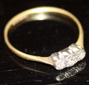 An 18 carat gold ring set with three small diamonds, 1.