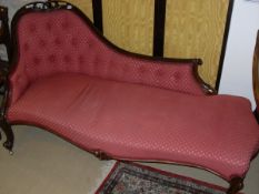 A Victorian show frame chaise longue with pierced and carved decoration,