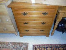 An Edwardian satin walnut chest of three long drawers raised on bracket feet