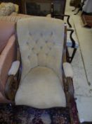 A mahogany framed armchair in pale gold button back upholstery, with shaped front rail,