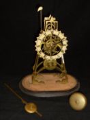 A brass skeleton clock with Roman numerals to the dial