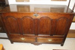 A late 19th Century oak mule chest with four arched panels to the front above two drawers and stile