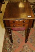 A Victorian mahogany drop-leaf work table, the plain top above two drawers,