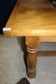 A 20th Century rectangular chestnut dining table with cleated end supports,
