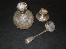 A cut glass scent bottle with silver rim and lid with embossed foliate decoration (by Horace