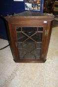 A 19th Century oak corner cabinet with astragal glazed doors opening to reveal three shaped shelves