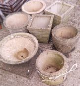 A collection of seven various composite stone garden pots