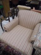 A modern armchair in the manner of Howard of London, in oatmeal ground and pink striped upholstery,