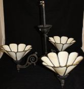 A three branch electrolier with cream coloured shades,