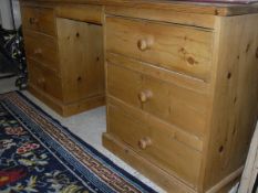 A modern pine dressing table of six assorted drawers to plinth base