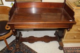 A mahogany washstand with towel rail, raised on two turned supports at the rear,