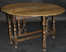 An 18th Century and later oak dining table,