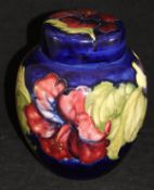 A 20th Century Moorcroft ginger jar of ovoid form decorated with pansies on a cobalt blue ground,