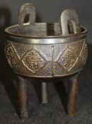 A Chinese bronze censer with two rectangular loop handles to the rim,