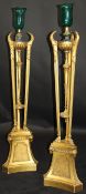 A pair of French floor standing giltwood torchères with green glass shades raised on a faux marble