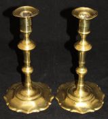 A pair of circa 1760 brass candlesticks with petal sconce, knopped stem and petal base, 20.