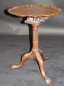 An early 19th Century mahogany tripod table, the plain top with pie crust edge above a birdcage,