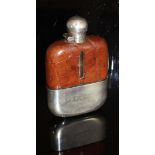 An early 20th Century hip flask with crocodile skin and plated mounts,
