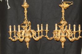 A pair of decorative six branch electroliers with gilt decoration in the Rococo manner with