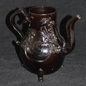 A Jackfield black glazed baluster coffee pot decorated in relief with grapes on a vine,