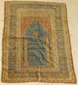 A fine Ushak prayer rug, the central panel set with Mihrab design on a blue ground,