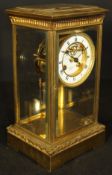 A gilt brass four glass mantle clock by J W Benson with two piece white enamel dial,