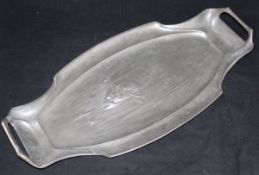 An Art Nouveau pewter fish platter with embossed decoration in the manner of Kayserzinn 64.8cm x 31.