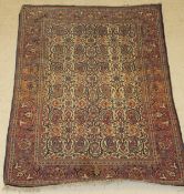 A Kashan rug, the central panel set with paisley style design on a cream ground,
