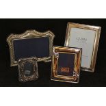 A collection of four various modern silver photograph frames of varying sizes and designs