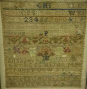 A 19th Century needlework sampler by Ann Smith featuring the alphabet, vase of flowers, numerals,