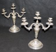 A pair of late 19th Century / early 20th Century white metal three light two branch candelabra with