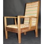 A circa 1926 Gordon Russell oak framed arm chair upholstered in a multi-coloured zig zag fabric,