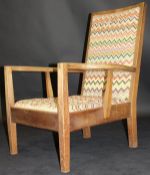 A circa 1926 Gordon Russell oak framed arm chair upholstered in a multi-coloured zig zag fabric,