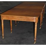 A Regency mahogany extending dining table, the rectangular end sections with rounded corners,