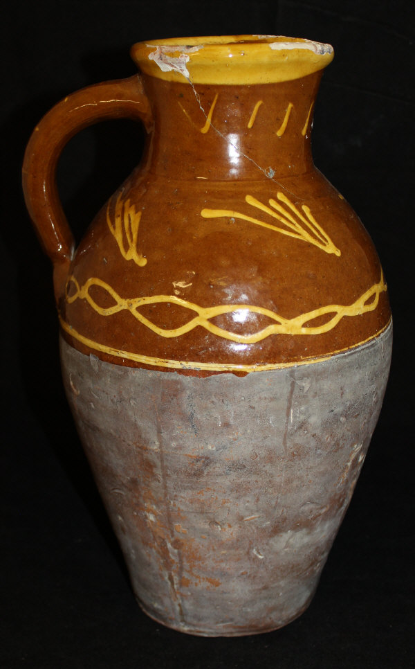 A 19th Century slip ware jug decorated with a yellow line slip decoration with yellow rim on a