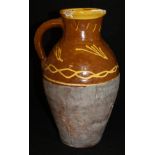 A 19th Century slip ware jug decorated with a yellow line slip decoration with yellow rim on a