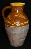 A 19th Century slip ware jug decorated with a yellow line slip decoration with yellow rim on a