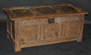An 18th Century oak coffer with panelled top,