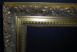 A large gilt picture frame with scrolling foliate decoration, approx 156.5 cm x 112.