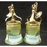 A pair of Arts & Crafts style hanging lamps, the brass mounts supporting coloured glass shades,