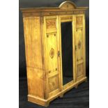 A late Victorian ash wardrobe compactum in the Aesthetic taste,