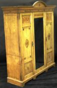 A late Victorian ash wardrobe compactum in the Aesthetic taste,