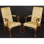 A pair of 19th Century mahogany arm chairs in a green and yellow flock upholstery,