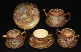 An early 20th Century Japanese six place part tea service in a "Thousand Flower" design on a red
