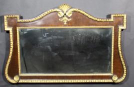 A mahogany and gesso decorated wall mirror in the George II style, the shaped top with shell,