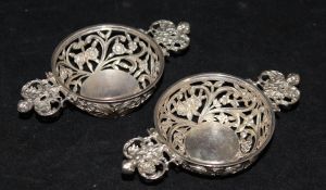 A matched pair of late Victorian silver twin-handled bonbon dishes with pierced and embossed