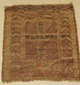 A Turkish prayer rug, the central panel set with geometric design on a red ground,