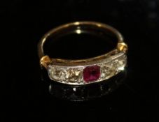 An un-marked gold and platinum set dress ring with central ruby flanked by four old cut graduated