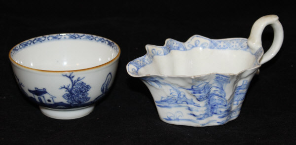 A circa 1750 Chinese export ware tea bowl decorated with blue house in a landscape on a white