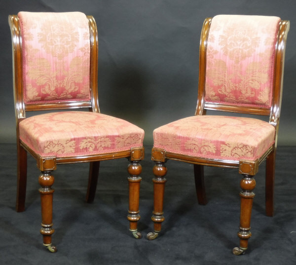 A set of six 19th Century mahogany framed dining chairs with pink ground upholstery,